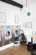 © Santi Nuñez/Stocksy - Mother and little boy doing laundry