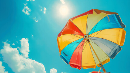 Vibrant Beach Umbrella Against a Sunny Blue Sky