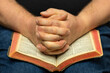 Praying Hands On A Open Bible