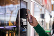 © Edward Córdoba / Andréas Sichel/Stocksy - A man paying with his mobile phone at a vending machine.