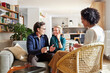 © ALTO IMAGES/Stocksy - Financial advisor visiting smiling couple at home