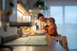© Santi Nuñez/Stocksy - Happy family cooking together