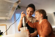 © Santi Nuñez/Stocksy - Happy family cooking together