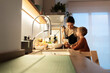 © Santi Nuñez/Stocksy - family cooking in the home kitchen