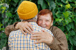 © Nata Segueza/Stocksy - An elderly couple exchanges a warm embrace outdoors