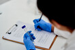 Science, clipboard and lab with test tube in hand, medic and microbiologist with research for vaccine study. Career, healthcare and laboratory documents for examination, biotechnology and writing