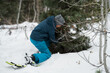 © Tara Romasanta Photography/Stocksy - Tween cutting down an evergreen tree.