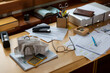 © Raymond Forbes LLC/Stocksy - Home office desk with receipts and paperwork