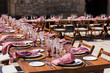 © Shava Cueva/Stocksy - A wedding setup of a table filled with elegant glasses and cups