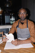 © Oleksii Syrotkin/Stocksy - Cafe Owner Working on Finances