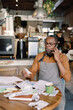 © Oleksii Syrotkin/Stocksy - Businessman on Phone with Papers