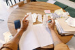 © Oleksii Syrotkin/Stocksy - Man sorting receipts