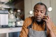 © Oleksii Syrotkin/Stocksy - Concerned chef on phone