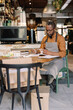 © Oleksii Syrotkin/Stocksy - Cafe owner running business