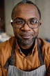 © Oleksii Syrotkin/Stocksy - Café Owner in Apron