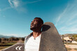 © Lucas Ottone/Stocksy - Portrait of black skateboarder