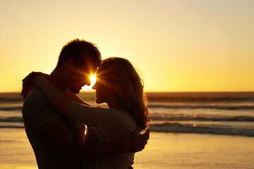 couple, love and kiss at beach with sunset for date or summer holiday and bonding in florida. relati