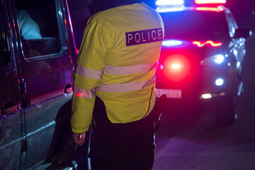 the traffic policeman stopped and checks the driver of the car