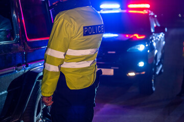 the traffic policeman stopped and checks the driver of the car