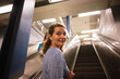 © Yakov Knyazev/Stocksy - Young Woman on Escalator in Subway Station