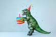 © Ruth Black/Stocksy - Dinosaur celebrating with a birthday cake with one birthday cand