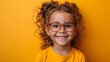 A smiling child wearing glasses with a plain background, promoting eye health and safety awareness month for children and adults