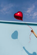 © Ángela Rober/Stocksy - Hand Holding Red Heart Balloon