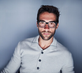 Fototapete - Man, portrait and night for research in studio on grey background with glasses as web designer. Website developer, deadline and overtime with creative or ideas for work, project and startup business