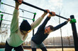 © BONNINSTUDIO/Stocksy - Father and son doing exercise on sports ground