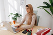 © Tania Cervian/Stocksy - Focused woman in hijab working remotely on laptop