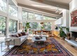wide angle shot of large bright mid century modern living room with white walls