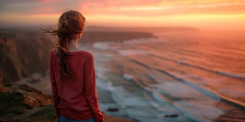 Poster - A woman standing on a cliff overlooking the ocean at sunset. Generative AI.