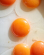 © Elena Kharichkina/Stocksy - Fresh Egg Yolks on a White Surface