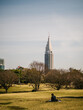© Nibuya Qubik/Stocksy - Man resting on the lawn of a park in central tokyo, Japan