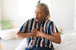 © Wavebreak Media - A senior African American woman with grey hair is having chest pains at home