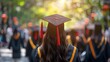 © HM Design - University graduates in graduation gowns and caps from behind during the commencement day.
