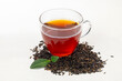 a cup of Chinese red tea with tea leaves.