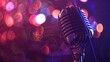 A close up of a vintage microphone against a blurred background of pink and purple lights.