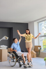 Wall Mural - Young man in wheelchair and his wife dancing on moving day