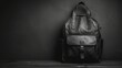   A monochrome image of a leather backpack atop a weathered wooden table, situated in a dimly lit room with a black wall serving as the background