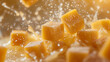 Fudge squares airborne in a rich dynamic mango slice confectionery scene
