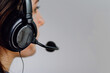 close-up photo a customer service representative wearing a headset while working diligently at a call center, against a clean white background, symbolizing efficiency and professio