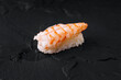 Fresh shrimp sushi on dark slate background
