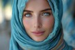 Vivid close-up portrait of a young woman with bright blue eyes and a headscarf