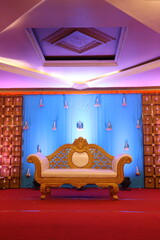 Wall Mural - Indian style stage decoration with blue backdrop decorated with lotus flowers and bells