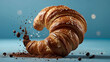 Croissant on a blue background, sprinkled with chocolate and powder