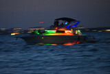 Fototapeta  - Kolorowy jacht oświetlony lampkami led, wieczorem na morzu karaibskim