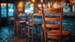 An old wooden bar stool stands solo by a counter in a warmly lit, traditional pub, inviting patrons to take a seat.