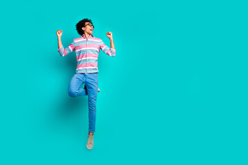 Canvas Print - Photo of overjoyed glad man wear trendy striped clothes look offer empty space isolated on cyan color background