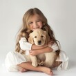 A smiling young girl hugging a golden retriever puppy on a white background.